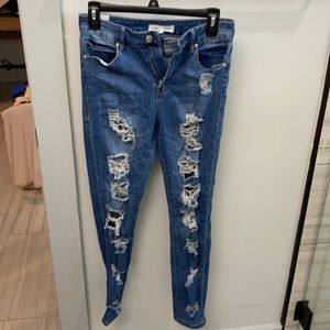 WORN size 5 jeans. Lots of rips throughout the leg. Skinny.